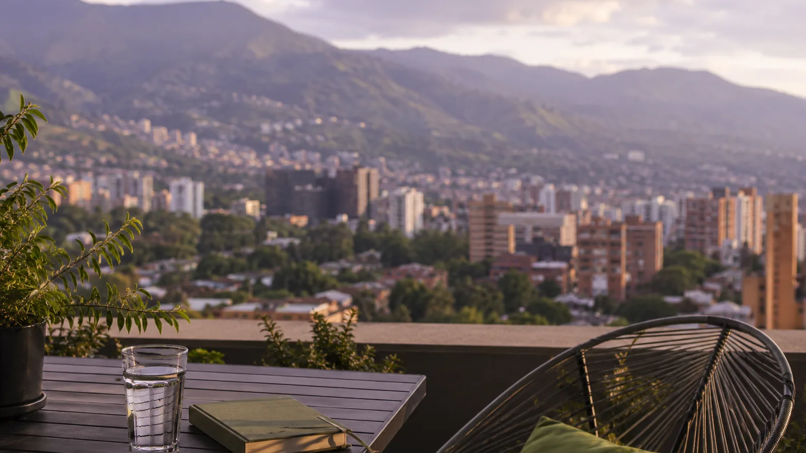 Medellin skyline at golden hour from an apartment terrace