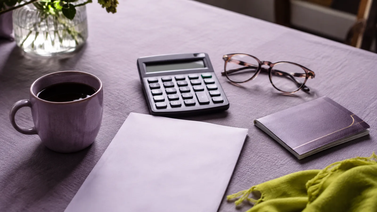 Reading glasses and a calculator on a table